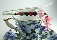 a tea cup with some beads on it