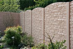 a stone wall in the middle of a garden