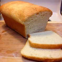 a loaf of bread sitting on top of a wooden cutting board