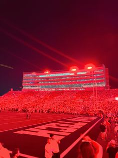 a stadium filled with lots of people at night