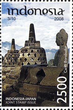 a stamp with an image of statues and mountains in the background on a postage stamp