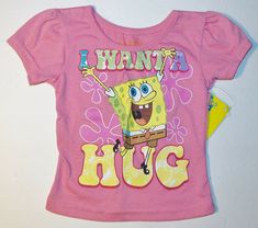 a pink shirt that says i want a hug on the front and an image of spongebob holding a book