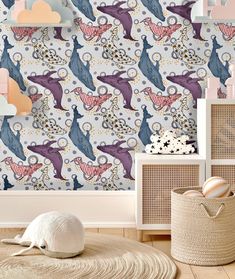 an animal themed wallpaper in a child's room with pink, blue and white accessories