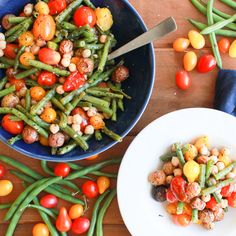 a bowl filled with green beans and tomatoes next to another bowl full of cherry tomatoes