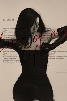 a woman is sitting on the floor with her arms behind her back and writing in red