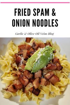 a white plate topped with pasta and bacon next to a green leaf on top of it