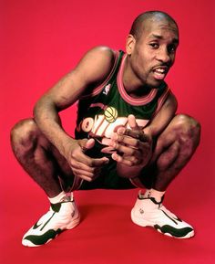 a man sitting on the ground holding a basketball