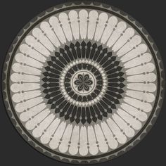 a black and white circular design on the floor in front of a dark background,