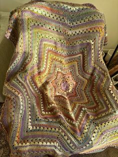 a crocheted blanket sitting on top of a couch