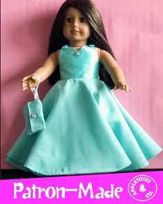 the doll is wearing a blue dress and holding a pair of scissors in her hand