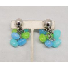 This is part of Chairish’s Costume Jewelry assortment.  1960s rhodium plated blue, aqua and lime green striated resin bead drops clip and screw back earrings. Marked "Napier." Measure: 2 7/8 inches long by 1 inch wide. Excellent condition.  Please reference the measurements noted in the description above for the best approximate dimensions. Please reach out to the seller under "Ask the Seller" for specific questions regarding the measurements. Blue Retro Clip-on Jewelry, Retro Green Clip-on Earrings, Blue Plates, Resin Beads, Modern Branding, Accessories Jewelry Earrings, Screw Back Earrings, Clip Earrings, Vintage 1960s