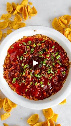 a white bowl filled with salsa and tortilla chips on top of a table