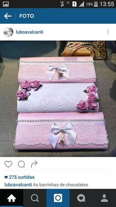 three pink boxes with bows and flowers on them