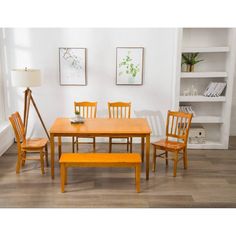 a dining room table with four chairs and a bench