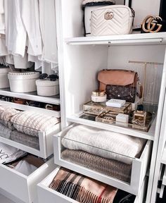 an organized closet with clothes, handbags and purses in white drawers on shelves