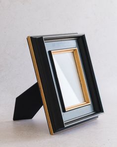 a black and gold frame sitting on top of a table