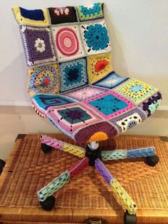 a crocheted chair sitting on top of a wicker box