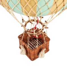 a hot air balloon that is in the shape of a basket with strings attached to it