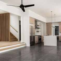 an empty living room and kitchen area in a house