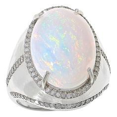 an opalite and diamond ring in white gold with diamonds on the sides,