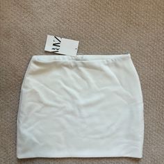 Mini Skirt With A High Waist. Side Hidden In-Seam Zip Closure. Out Of Stock. Fitted Zara Skort In Solid Color, Zara Stretch Mini Skirt, Zara Stretch Solid Color Skirt, Zara High Waist White Mini Skirt, Zara White Mini Bottoms, Zara White Mini Skirt, Zara High-waist White Skirt, Zara White Lined Mini Skirt, Zara Skort