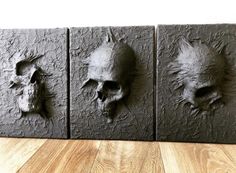 three pieces of art that have been made to look like skulls