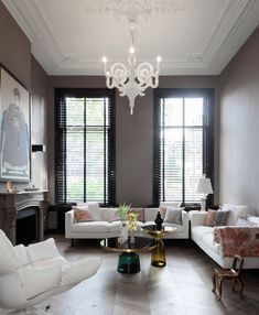 a living room filled with lots of white furniture