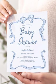 a person holding up a baby shower card