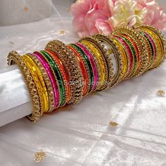 2 Large stacks of antique gold base and crystal detail luxury bangles with a mix of Pinks, oranges, yellows and green for that perfect mehndi night look! Ready to Ship with gift boxing. Bridal Bangle Set, Mehndi Night, Bridal Bangles, Pierced Jewelry, Bangle Set, Night Looks, Gold Jewelry Fashion, All Colors, Hair Pieces