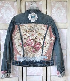 a denim jacket with flowers on the back