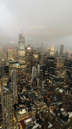 an aerial view of the city lights and skyscrapers on a foggy day in new york city