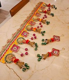 a table topped with lots of colorful necklaces on top of a marble countertop