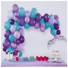 a table with balloons and cake on it