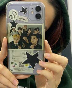 a woman holding up a cell phone case with photos on the front and back of it