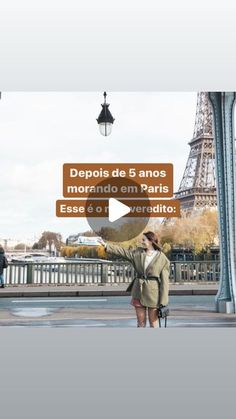 two people are standing in front of the eiffel tower and looking up into the sky