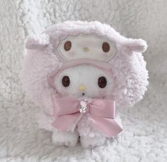 a hello kitty stuffed animal with a pink bow on it's head and ears