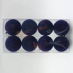 eight black balls in a clear plastic package