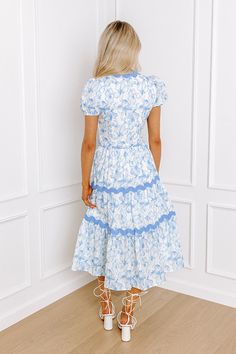 - This beautiful dress is garden party goals! - Material with a blue hued floral print - A built-in partial lining that ends above the knee - A scalloped v-cut neckline that goes into a button down bodice - Short puff sleeves with elastic cuffs - Side zip closure - A fitted waistline - Scalloped accents - Hidden side pockets - A relaxed silhouette that ends in a midi length hemline Church Dress, Blue Garden, Church Dresses, V Cut, V Cuts, Beautiful Dress, Above The Knee, Special Occasion Dresses, Garden Party