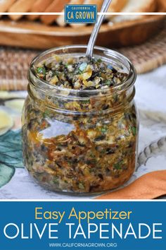 an easy appetizer with olive tapenad in a glass jar and a spoon