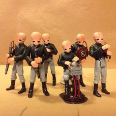 five toy soldiers standing next to each other