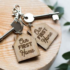 three wooden keychains with the words our first home engraved on them