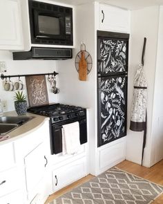 a kitchen with an oven, microwave and towel rack in the wall next to the stove