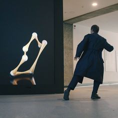 a man standing in front of a display of bones