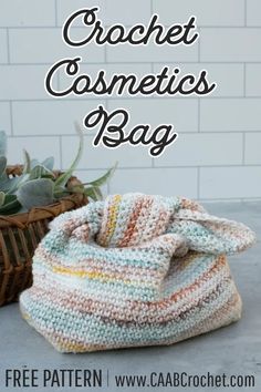 a crochet bag sitting next to a basket with succulents in it