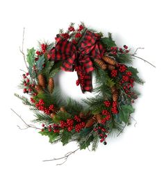 a christmas wreath with pine cones and berries