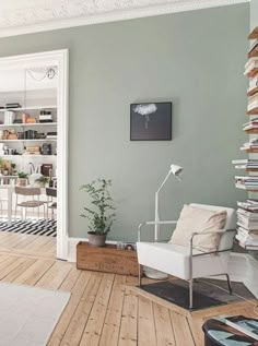 a living room filled with furniture and lots of books on the shelves next to a doorway