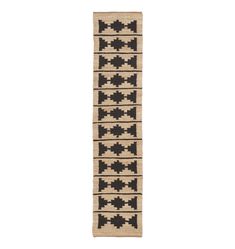 a black and white rug with geometric designs on the bottom, in front of a white background