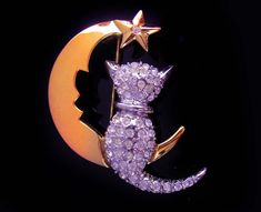 For the person who wants a little magic in their life, this fabulous kitty sits on a moon and star brooch will bring in the compliments ! 1-5-20 Silver Star Brooch For Gift, Gold Cat Design Brooches For Gift, Gold Cat Design Brooch For Gift, Celestial Style Brooch Jewelry As Gift, Celestial Brooch Jewelry As Gift, Gold Brooch With Cat Design For Gift, Celestial Brooch Jewelry As A Gift, Gold Star Brooches As Gift, Vintage Crescent Brooch For Gift