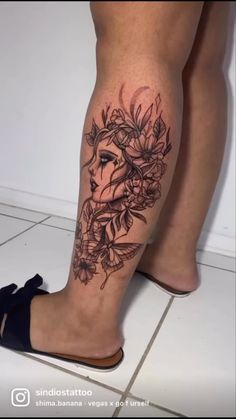 a woman's legs with flowers and a face tattoo on her left calf area