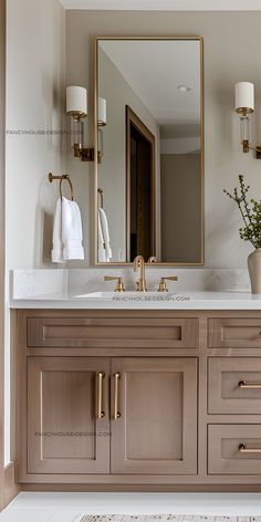 a bathroom with two sinks and a large mirror